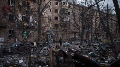 A police officer at abandoned residential buildings in Kyiv. AP