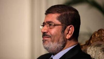Egyptian President Mohammed Morsi poses, but couldn't reach an agreement with his opponents yesterday.