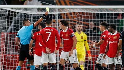 United's Lisandro Martinez is shown a yellow card by referee Marco Di Bello after he concedes a penalty. Reuters