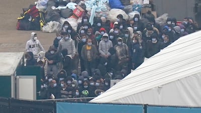 Migrants wait to be processed in Dover, Kent, after arriving on a small boat earlier this month. PA