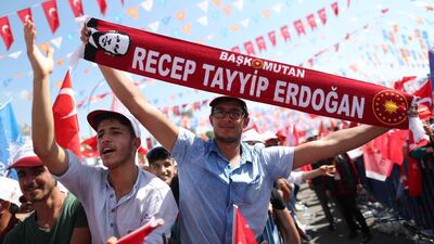 Supporters of Turkish President Recep Tayyip Erdogan hold scarfs during a campaign rally. Erdem Sahin / EPA