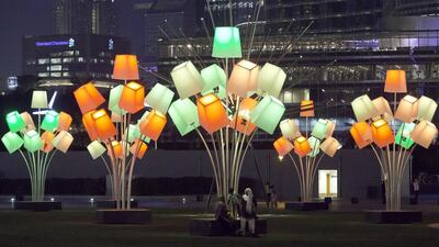 Families enjoy the Festival of Lights at the Burj Park in Downtown Dubai. More than 30 artists will take part to display well-known buildings and landmarks around the city during the inaugural event. Jaime Puebla / The National