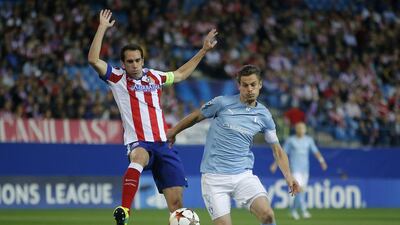 Malmo's Markus Rosenberg, right, challenges for the ball with Atletico's Diego Godin during their Champions League match on Wednesday. Andres Kudacki / AP