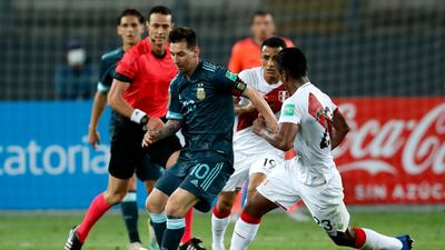 Lionel Messi of Argentina fights for the ball with Pedro Aquino of Peru. Getty Images