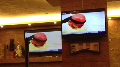 An episode of the Lebanese prank show Hadde Albak featuring the kidnapping of actor Wajih Sakr is seen on televisions in a Beirut cafe in June 2016. Josh Wood for The National