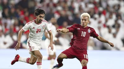 Khalfan Mubarak of UAE and Chanathip Songkrasin of Thailand battle.