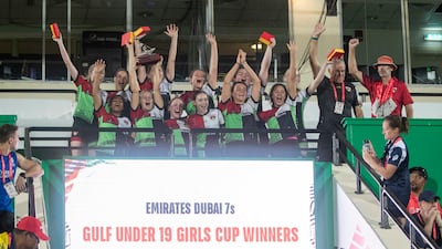 Abu Dhabi Harlequins celebrate with the trophy after beating Dubai Collage in the Gulf Under 19 Girls final at Dubai Sevens. All photos Ruel Pableo for The National