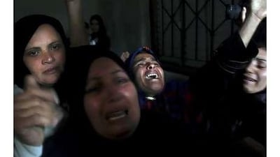 Palestinian relatives of Haya Hamdan, four, and her sister, Lama, 12, who were killed in an Israeli attack, mourn at their funeral in Gaza Strip.