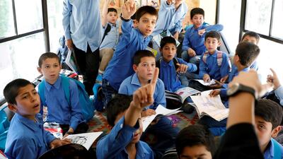 School boys are seen inside inside a mobile library bus.