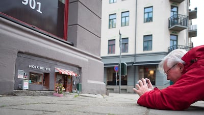 A pedestrian takes a photo of the mini restaurant and deli shop. AFP