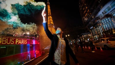 Parisians ring in the New Year 2021 near the Eiffel Tower. New Year's eve celebrations and fireworks have been cancelled throughout France with an 8 o'clock curfew imposed in a bid to curb the spread of Covid-19 infections. Getty Images