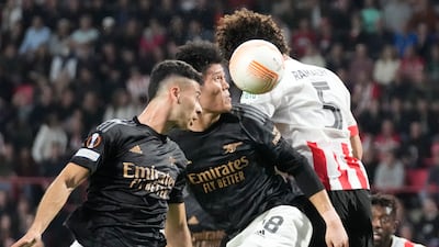Arsenal's Takehiro Tomiyasu and Gabriel Martinelli jump for a header with PSV's Andre Ramalho. AP