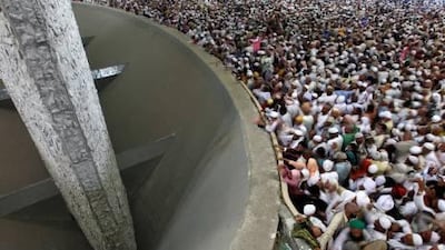 Muslim pilgrims cast stones at a pillar, symbolizing the stoning of Satan, in the ritual of Jamarat, the last rite of the annual Haj, in Mina today.
