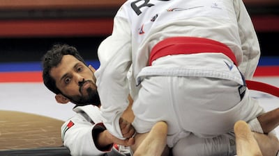 Talib Al Kirbi, left, of UAE and Remus Corbei of Romania compete at the JJIF World Championship in Abu Dhabi. Satish Kumar for The National