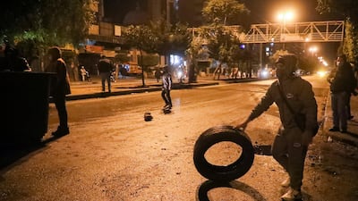 A demonstrator holds a tire during a protest against the lockdown and worsening economic conditions, amid the spread of the coronavirus disease (COVID-19), in Tripoli, Lebanon. Reuters