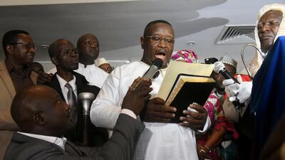Opposition candidate and former military junta leader Julius Maada Bio takes his oath as Sierra Leone's new president in Freetown. Olivia Acland / Reuters