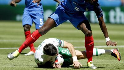 Paul Pogba of France fouls Shane Long of Ireland in the penalty box. Yuri Kochetkov / EPA