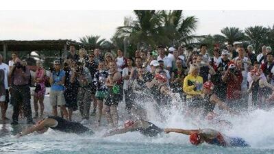 Women make a splash at the start of their race on the Corniche yesterday. Mike Young / The National