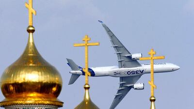 An Airbus A350 XWB aircraft flies over the domes of an Orthodox church during the MAKS 2015. Maxim Shemetov / Reuters