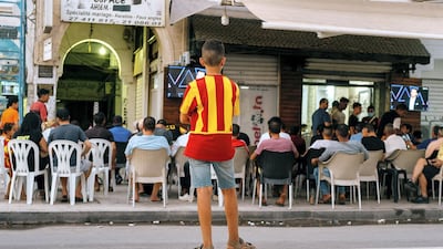 Supporters of Esperance Sportive de Tunis, the local football team of Bab Souika district in the Tunisian capital, settle in to watch the second leg of the club's CAF Champions League semi-final tie against Al Ahly of Egypt. Erin Clare Brown/ The National