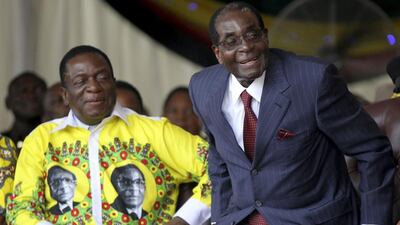 Zimbabwe's President Robert Mugabe shares a joke with his vice-President Emmerson Mnangagwa during Mugabe's birthday celebrations at Great Zimbabwe in Masvingo, February 27, 2016. REUTERS/Philimon Bulawayo