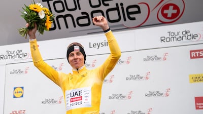 UAE Team Emirates XRG's Slovenian rider Tadej Pogacar, wearing the overall leader's yellow jersey, on the podium after winning the Tour of Romandie. AFP