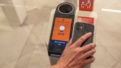A customer uses their smart phone to enter the Amazon Go location in New York. Starbucks via AP