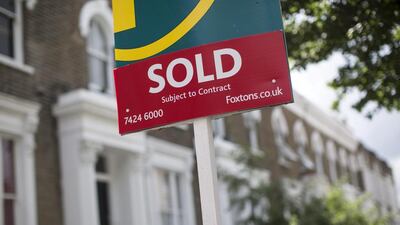 An estate agent's sold sign is displayed outside a property in London. Interest in cut-price homes has spurred a surge of interest among Chinese buyers post-Brexit. Oli Scarff / Getty Images