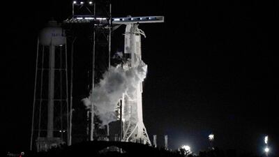 The Crew Dragon spacecraft reached orbit shortly before dawn, Nasa commentators said, with the Falcon 9 booster rocket touching down on one of the company's autonomous drone ships in the Atlantic Ocean. AP Photo