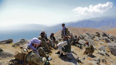 Afghan resistance movement and anti-Taliban uprising forces rest on a hilltop in Darband. AFP