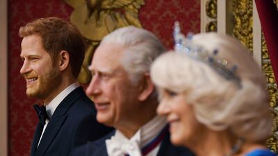 A wax figure of Prince Harry, left, has been moved back into the display containing other members of the British royal family. AP