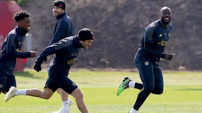 Manchester United players Romelu Lukaku, right, races with teammate Juan Mata. Reuters