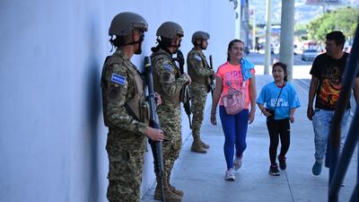 Soldiers stand guard during the presidential and legislative elections in San Salvador, El Salvador. AFP