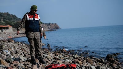 A Turkish paramilitary officer looks at the body of a child washed up on a beach in Canakkale’s Bademli district yesterday. Ozan Kose / AFP