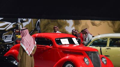 Visitors view classic cars displayed for sale in a special exhibition, during the Riyadh Motor Show at Al-Janadriyah village in the Saudi capital. AFP