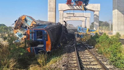 The wreckage of a passenger train lies at the side of the tracks in Thailand after a crane collapsed on it, killing more than 20 people. EPA