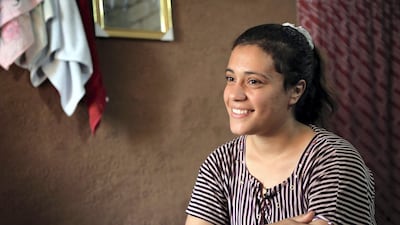 Iraq's Yazidi Jihan Qassem, 18, smiles as she talks to a AFP reporter at a makeshift house in an area housing many displaced people on the outskirts of the northwestern Iraqi town of Baadre. AFP