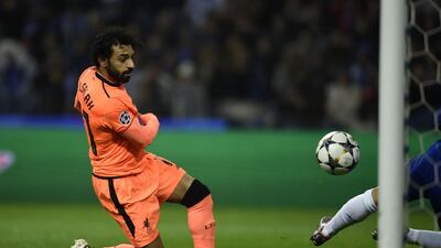Liverpool's Egyptian midfielder Mohamed Salah shoots past Porto's Portuguese goalkeeper Jose Sa to score their second goal in the first leg of the Uefa Champions League last-16 tie at the Dragao in Porto. Miguel Riopa / AFP
