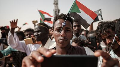 A man poses for a selfie as he awaits the arrival of the deputy head of Sudan's ruling Transitional Military Council during a rally in the village of Abraq, near Khartoum. AFP