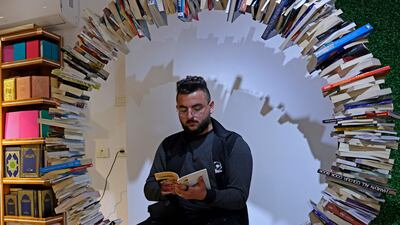 A Palestinian attends the reopening of the new Samir Mansour bookshop after it was destroyed during last year's 11-day war between Israel and the Palestinian Hamas movement, in Gaza City. Mansour's beloved bookshop has been rebuilt and restocked following an international fundraiser.