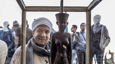 A wooden statue of the goddess Neith is displayed after the announcement of a new discovery carried out by an Egyptian archaeological team in Giza's Saqqara necropolis, south of the capital Cairo. AFP