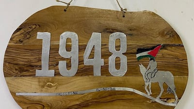 A wall sign made from olive wood to commemorate the 1948 Nakba. Photo: Art48House / Instagram