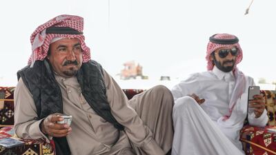 Abu Dhabi, United Arab Emirates, December 11,2019. -- Mohammed Al Merri discusses camel pageant strategy at his family's tent in the dunes of Al Dhafra. Victor Besa/The National Section: NA Reporter: Anna Zacharias
