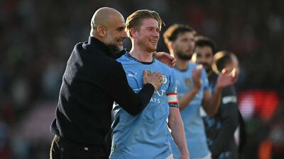 Kevin De Bruyne, right, celebrates with Manchester City manager Pep Guardiola after their FA Cup win over Bournemouth. AFP
