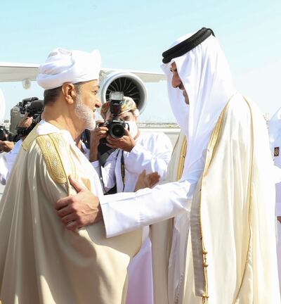 Qatar's Emir Sheikh Tamim bin Hamad Al Thani, right, receives Oman's Sultan Haitham at Doha International Airport. Reuters