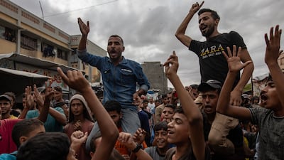 Palestinians celebrate the announcement of a ceasefire agreement between Hamas and Israel in Khan Younis, in the southern Gaza Strip. EPA