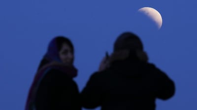 A couple watches the eclipse in Buenos Aires, Argentina. AP Photo/Natacha Pisarenko