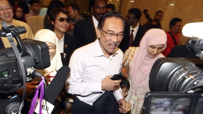Malaysia's top court on Tuesday upheld the sodomy conviction of opposition leader Anwar Ibrahim, centre, seen here arriving at a court house in Putrajaya, Malaysia. AP Photo MALAYSIA OUT