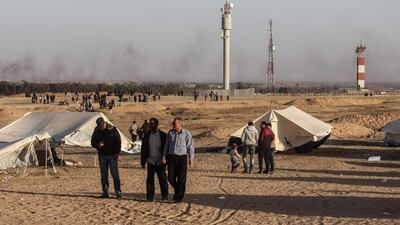 Palestinians gather at the site of a protest on April 8, 2018, on the Israel-Gaza border east of Rafah in the southern Gaza Strip. Said Khatib / AFP