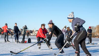 People play ice hockey in Copenhagen. The price of happiness in Denmark is $109,142. Photo: AFP